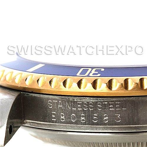 This image shows a close-up side view of a Rolex Submariner 16613 Men's Steel and Gold (two tone) Blue Dial 16613 Men's Steel and Gold (two tone) Blue Dial watch, focusing on the bezel and engraved stainless steel case.