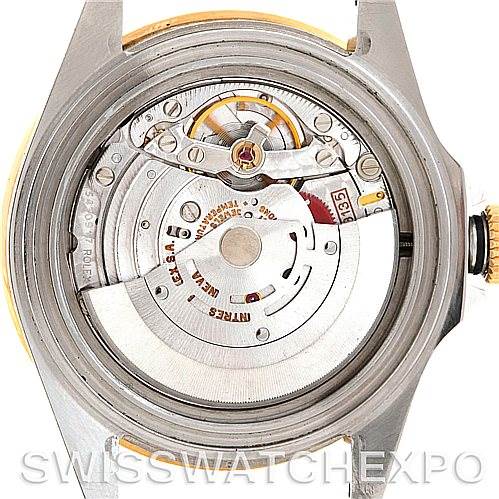 This image shows the movement of the Rolex Submariner 16613 Men's Steel and Gold (two tone) Blue Dial 16613 Men's Steel and Gold (two tone) Blue Dial watch from a back view, highlighting the intricate mechanics inside.