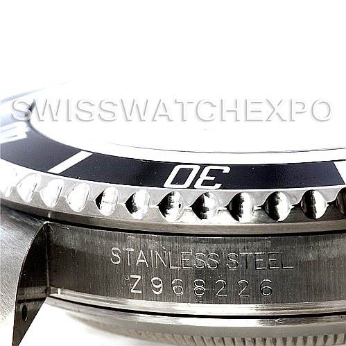 This close-up image shows the bezel, case, and part of the serial number of a Rolex Submariner 16610 Men
s Stainless Steel Black Dial 16610 Men
s Stainless Steel Black Dial watch.