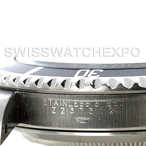 This image shows a close-up of the side view of the Rolex Submariner 14060 Men
s Stainless Steel Black Dial 14060 Men
s Stainless Steel Black Dial watch, highlighting the stainless steel case and serial number.