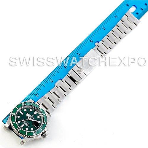 The image shows a Rolex Submariner 116610 Men's Stainless Steel Green Dial 116610 Men's Stainless Steel Green Dial watch laid flat next to a blue ruler, displaying the watch face and full bracelet.