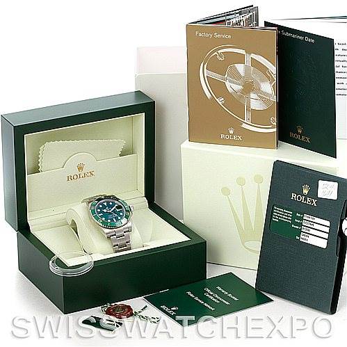 The image shows a Rolex Submariner 116610 Men's Stainless Steel Green Dial 116610 Men's Stainless Steel Green Dial watch at an angle within its box, accompanied by booklets, tags, and accessories.