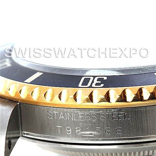 This close-up angle of the Rolex Submariner 16613 Men's Steel and Gold (two tone) Black Dial 16613 Men's Steel and Gold (two tone) Black Dial shows the bezel, the "30" marker, and part of the case with "STAINLESS STEEL" engraving.
