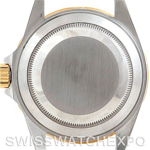 This image shows the stainless steel case back and a portion of the crown of a Rolex Submariner 16613 Men's Steel and Gold (two tone) Black Dial 16613 Men's Steel and Gold (two tone) Black Dial watch.