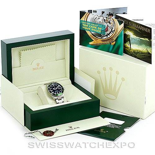 The image shows a Rolex Submariner 16610LV Men
s Stainless Steel Black Dial 16610LV Men
s Stainless Steel Black Dial watch in its original box with accompanying accessories, documentation, and outer packaging.