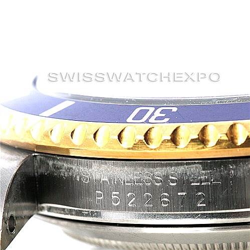 This image shows a close-up side angle of a Rolex Submariner 16613 Men's Steel and Gold (two tone) Blue Dial 16613 Men's Steel and Gold (two tone) Blue Dial watch, highlighting the bezel and part of the stainless steel case with the engraved serial number.