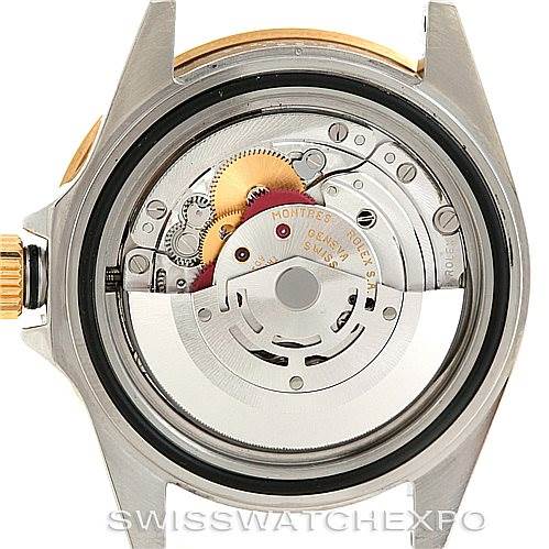 This image shows the inner mechanism and movement of a Rolex Submariner 16613 Men's Steel and Gold (two tone) Blue Dial 16613 Men's Steel and Gold (two tone) Blue Dial watch from a rear, close-up angle.