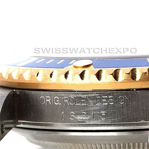 The image shows a close-up side view of the Rolex Submariner 16613 Men's Steel and Gold (two tone) Blue Dial 16613 Men's Steel and Gold (two tone) Blue Dial's bezel and case with engraved design and model number.