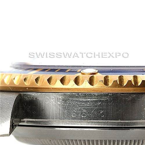 This close-up image shows the bezel and case side of a Rolex Submariner 16613 Men's Steel and Gold (two tone) Blue Dial 16613 Men's Steel and Gold (two tone) Blue Dial model, displaying the serial number engraved.