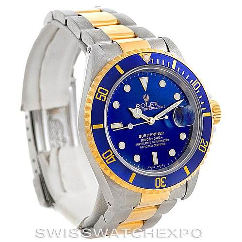 The image shows a Rolex Submariner 16613 Men's Steel and Gold (two tone) Blue Dial 16613 Men's Steel and Gold (two tone) Blue Dial watch from a three-quarter view angle, highlighting the blue dial, bezel, and two-tone bracelet.