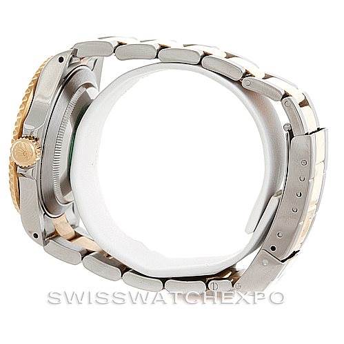 The Rolex Submariner 16613 Men
s Steel and Gold (two tone) Grey Dial 16613 Men
s Steel and Gold (two tone) Grey Dial watch is shown from a side-angle, displaying its metal bracelet, clasp, and the edge of its crown.