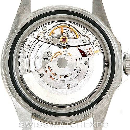 The image shows the back view of the Rolex Submariner 16610 Men
s Stainless Steel Black Dial 16610 Men
s Stainless Steel Black Dial watch, specifically its exposed movement and inner mechanisms.