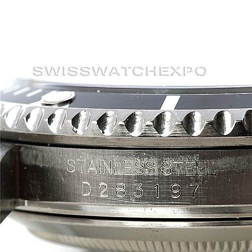 The image shows a close-up of the side of a Rolex Submariner 16610 Men
s Stainless Steel Black Dial 16610 Men
s Stainless Steel Black Dial watch, displaying the serial number and part of the bezel.