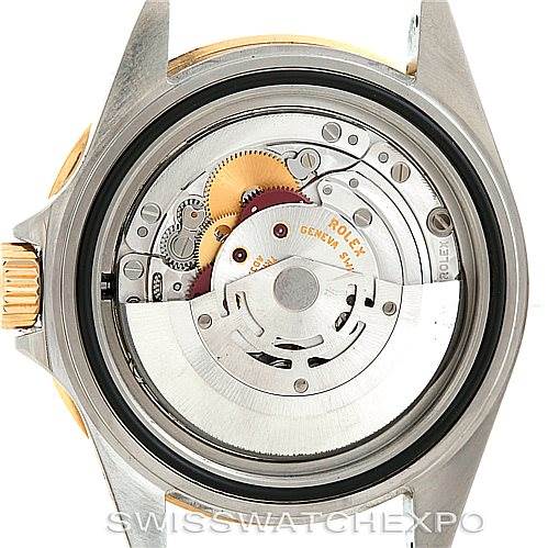 The image shows the internal mechanics of a Rolex Submariner 16613 Men's Steel and Gold (two tone) Black Dial 16613 Men's Steel and Gold (two tone) Black Dial watch from a back view, displaying the movement and rotor.