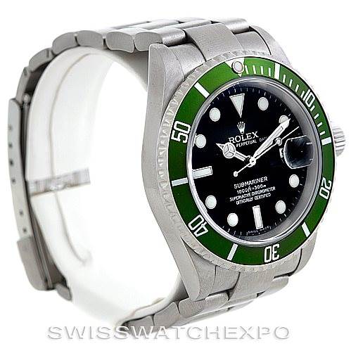 The image shows a Rolex Submariner 16610T Men
s Stainless Steel Black Dial 16610T Men
s Stainless Steel Black Dial watch at an angle displaying its face, green bezel, and part of the bracelet.