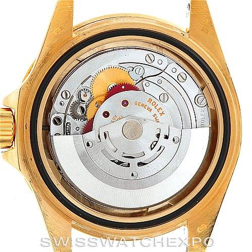 This image shows the back view of a Rolex Submariner 16618 Men's Yellow Gold Blue Dial 16618 Men's Yellow Gold Blue Dial watch, highlighting its movement and internal mechanics.