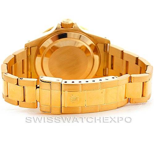 This image shows the back view of the Rolex Submariner 16618 Men's Yellow Gold Blue Dial 16618 Men's Yellow Gold Blue Dial watch, highlighting its gold bracelet and clasp.