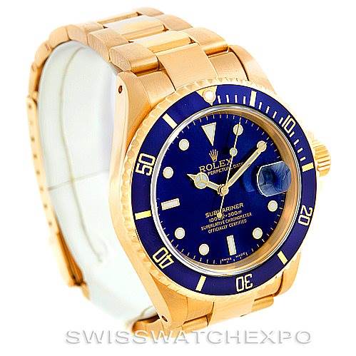 The Rolex Submariner 16618 Men's Yellow Gold Blue Dial 16618 Men's Yellow Gold Blue Dial watch is shown at an oblique angle, highlighting the blue dial, rotating bezel, and gold bracelet.