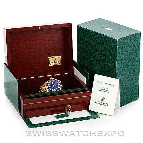 The image shows a Rolex Submariner 16618 Men's Yellow Gold Blue Dial 16618 Men's Yellow Gold Blue Dial watch inside its open wooden box, along with its green outer box and accompanying documentation.