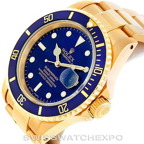 The image shows an angled view of the Rolex Submariner 16618 Men's Yellow Gold Blue Dial 16618 Men's Yellow Gold Blue Dial watch, displaying its blue dial, bezel, case, crown, and part of the bracelet.