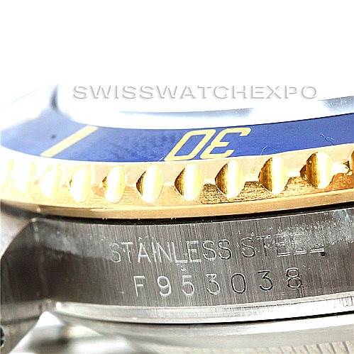 This close-up angle of the Rolex Submariner 16613 Men's Steel and Gold (two tone) Grey Dial 16613 Men's Steel and Gold (two tone) Grey Dial shows part of the bezel, dial, and the stainless steel case with a serial number.