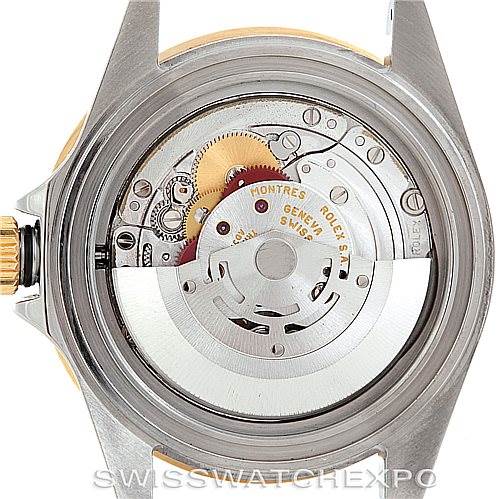 The image shows the back view of a Rolex Submariner 16613 Men's Steel and Gold (two tone) Grey Dial 16613 Men's Steel and Gold (two tone) Grey Dial watch with its case back removed, revealing the movement mechanism.