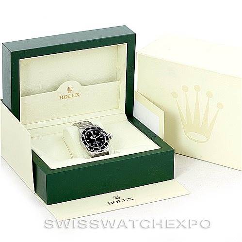 The image shows a Rolex Submariner 14060 Men
s Stainless Steel Black Dial 14060 Men
s Stainless Steel Black Dial watch in a green Rolex presentation box with an outer cream-colored box.