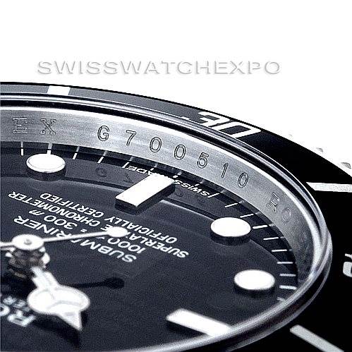 Close-up of a Rolex Submariner 14060 Men
s Stainless Steel Black Dial 14060 Men
s Stainless Steel Black Dial watch showing the bezel, dial, hands, and part of the rehaut with engraved serial number.
