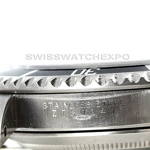 This image shows a close-up side view of the Rolex Submariner 14060 Men
s Stainless Steel Black Dial 14060 Men
s Stainless Steel Black Dial
s stainless steel case with the serial number engraved.