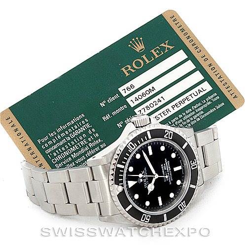 The image displays a Rolex Submariner 14060 Men
s Stainless Steel Black Dial 14060 Men
s Stainless Steel Black Dial watch at an angled top-down view, alongside its green certification card.