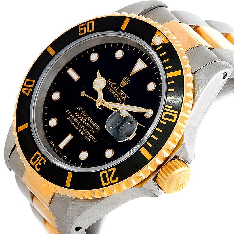 The image shows a close-up angle of a Rolex Submariner 16613 Men's Steel and Gold (two tone) Black Dial 16613 Men's Steel and Gold (two tone) Black Dial watch, highlighting its bezel, dial, and crown.