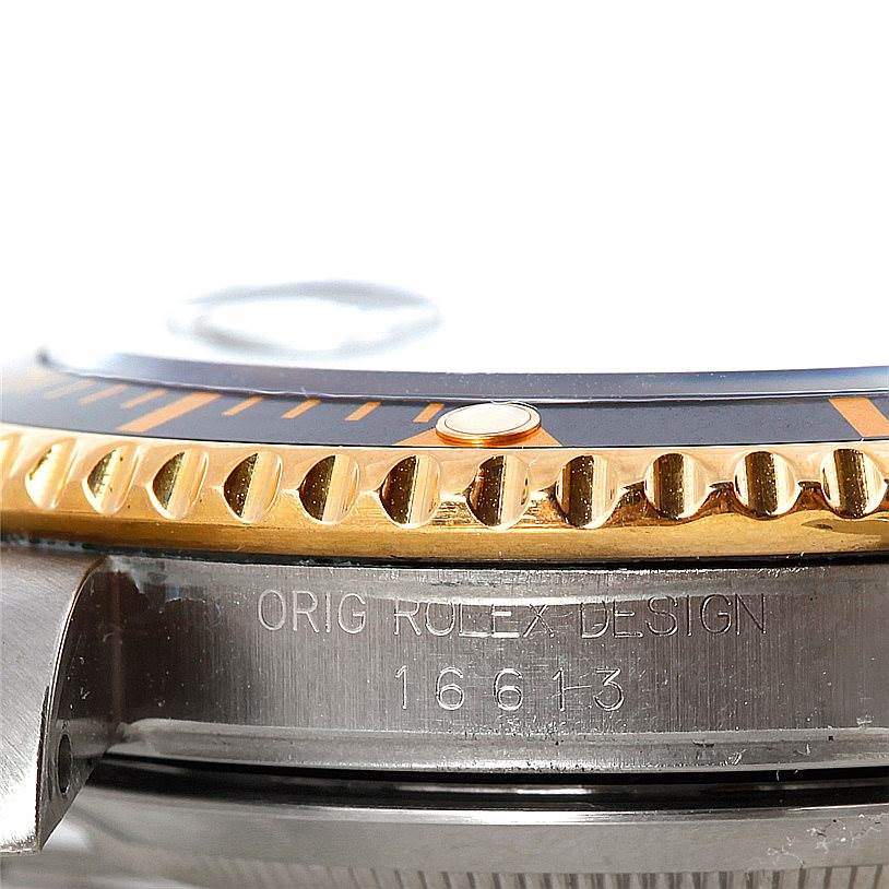 The image shows a side view of a Rolex Submariner 16613 Men's Steel and Gold (two tone) Black Dial 16613 Men's Steel and Gold (two tone) Black Dial watch, highlighting the bezel, edge of the crystal, and engraved model number.