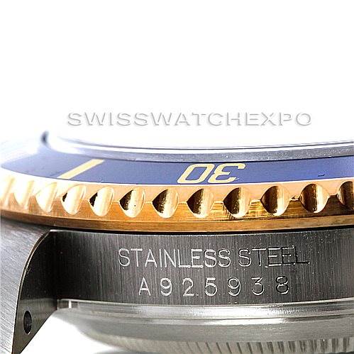 This image shows a close-up of the side view of the Rolex Submariner 16613 Men's Steel and Gold (two tone) Blue Dial 16613 Men's Steel and Gold (two tone) Blue Dial watch bezel and part of the case, highlighting the stainless steel material and serial number.