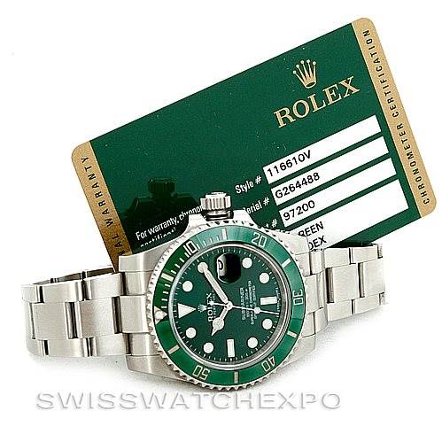 The image shows a Rolex Submariner 116610LV Men's Stainless Steel Green Dial 116610LV Men's Stainless Steel Green Dial watch with a green bezel and a metal bracelet at a slightly angled top-down view, alongside its certification card.