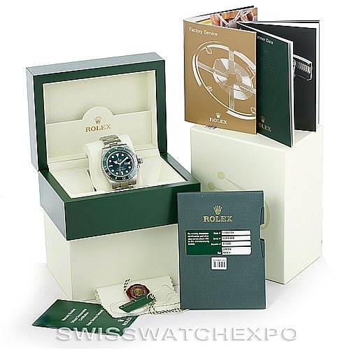 The image shows a Rolex Submariner 116610LV Men's Stainless Steel Green Dial 116610LV Men's Stainless Steel Green Dial with its box, tags, manuals, and warranty card placed at various angles.