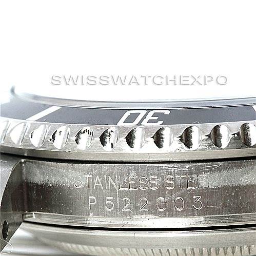 The image shows a close-up side view of the bezel, case, and part of the lug of a Rolex Submariner 16610 Men's Stainless Steel Black Dial 16610 Men's Stainless Steel Black Dial watch, highlighting its stainless steel marking and serial number.