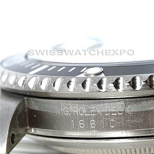 Close-up of the Rolex Submariner 16610 Men's Stainless Steel Black Dial 16610 Men's Stainless Steel Black Dial model, showing the bezel, crown guard, and part of the case with design engraving.