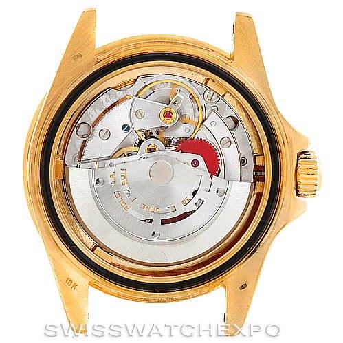 The image shows the back view of a Rolex Submariner 16808 Men's Yellow Gold Blue Dial 16808 Men's Yellow Gold Blue Dial, exposing its mechanical movement inside the gold case.