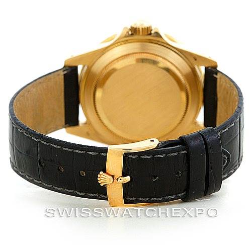 This image shows the back of a Rolex Submariner 16808 Men's Yellow Gold Blue Dial 16808 Men's Yellow Gold Blue Dial watch, focusing on its gold case and black leather strap.