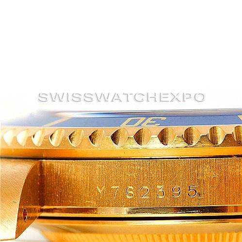 This image shows a close-up side view of the bezel, case, and serial number of a Rolex Submariner 16618 Men's Yellow Gold Blue Dial 16618 Men's Yellow Gold Blue Dial watch.