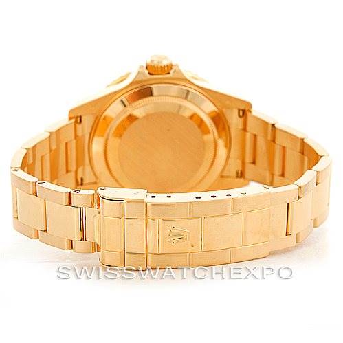 This image shows the backside and clasp of a Rolex Submariner 16618 Men's Yellow Gold Blue Dial 16618 Men's Yellow Gold Blue Dial, focusing on its gold bracelet and the closed caseback.