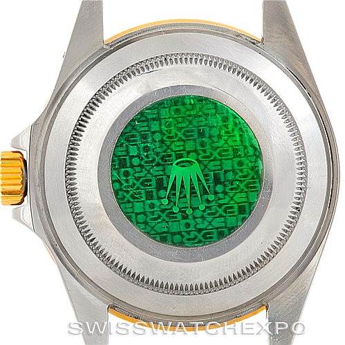 This image shows the case back of a Rolex Submariner 16613 Men's Steel and Gold (two tone) Blue Dial 16613 Men's Steel and Gold (two tone) Blue Dial watch with its holographic sticker.
