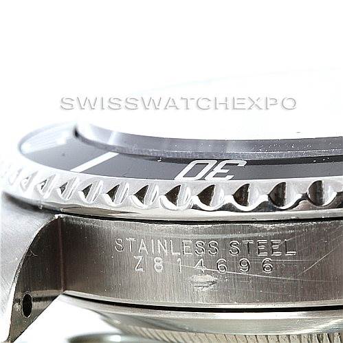 This side-angle photo of the Rolex Submariner 14060 Men's Stainless Steel Black Dial 14060 Men's Stainless Steel Black Dial shows the case, bezel, and part of the model's engraved serial number.