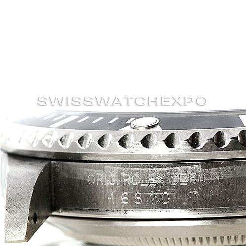 This close-up angle of the Rolex Submariner 16610 Men's Stainless Steel Black Dial 16610 Men's Stainless Steel Black Dial shows the edge of the bezel and part of the case with engraved markings.