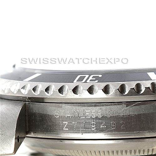 The image shows a close-up of the side view of a Rolex Submariner 16610 Men's Stainless Steel Black Dial 16610 Men's Stainless Steel Black Dial, highlighting the model's bezel and engravings on the stainless steel case.
