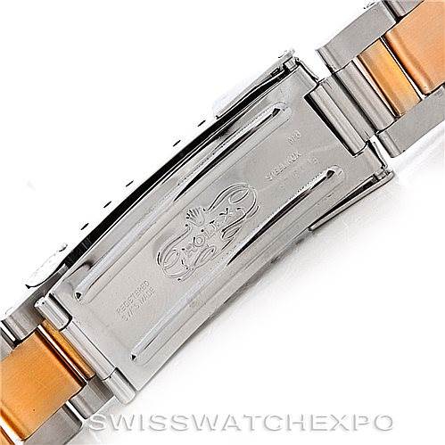 This image shows the clasp of a Rolex Submariner 16613 Men
s Steel and Gold (two tone) Black Dial 16613 Men
s Steel and Gold (two tone) Black Dial bracelet, featuring a mix of silver and gold tones with the Rolex logo engraved.