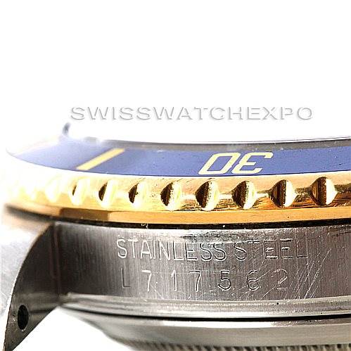 The image shows a close-up angle of the bezel and case side of a Rolex Submariner 16613 Men's Steel and Gold (two tone) Blue Dial 16613 Men's Steel and Gold (two tone) Blue Dial, highlighting the "Stainless Steel" engraving.