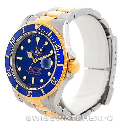 The image shows a close-up, angled view of a Rolex Submariner 16613 Men's Steel and Gold (two tone) Blue Dial 16613 Men's Steel and Gold (two tone) Blue Dial watch, highlighting the bezel, dial, crown, and two-tone bracelet.