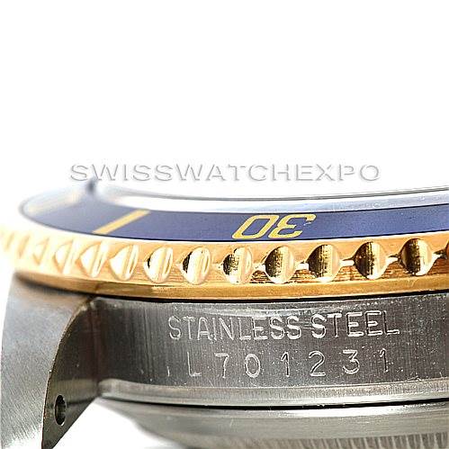 This image shows a close-up of the side profile of the Rolex Submariner 16613 Men
s Steel and Gold (two tone) Blue Dial 16613 Men
s Steel and Gold (two tone) Blue Dial, focusing on the bezel and engraving on the stainless steel case.