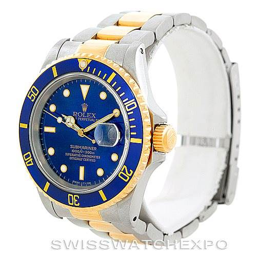 This image shows a Rolex Submariner 16613 Men
s Steel and Gold (two tone) Blue Dial 16613 Men
s Steel and Gold (two tone) Blue Dial watch at a three-quarter angle, highlighting its blue dial, bezel, and two-tone bracelet.